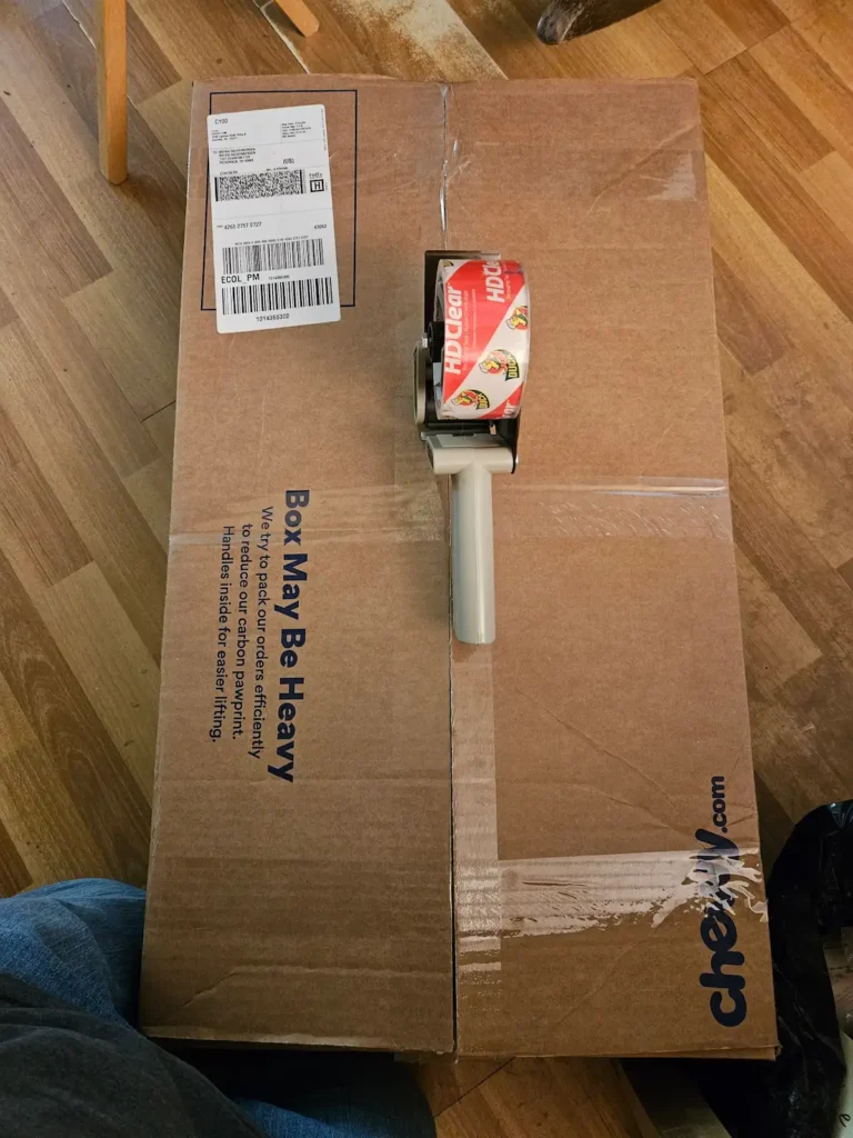 using a tape gun to tape a box