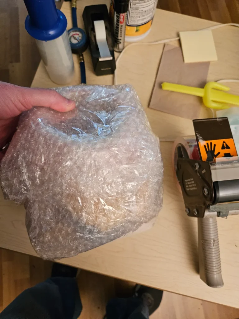 Using bubble wrap to wrap fragile items during home clearout